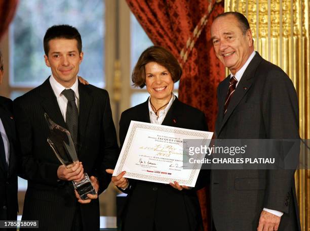 France's President Jacques Chirac poses with Dany Breuil and her son Jean-Christophe Breuil, heads of Smoby group after they received the " Audace...