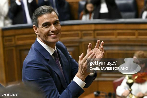 Spain's acting Prime Minister Pedro Sanchez applauds during a parliamentary debate ahead of a vote to elect Spain's next premier, at the Congress of...