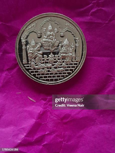 lord ganesh /goddess lakshmi/goddess saraswati silver coin on a pink paper/dhanteras/diwali/deepavali festival - laxmi ganesh stock pictures, royalty-free photos & images