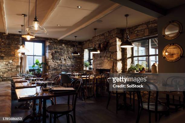 an empty rustic restaurant - cosy pub stock pictures, royalty-free photos & images