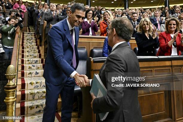 Spains acting prime minister pedro sanchez is congratulated by partido popular leader alberto Spains acting prime minister pedro sanchez is congratulated by partido popular leader alberto