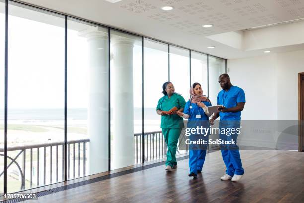 a collaborative approach to patient wellbeing - frontline worker stock pictures, royalty-free photos & images