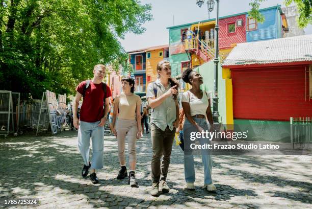 tourist friends walking and talking on the street - caminito buenos aires stock pictures, royalty-free photos & images