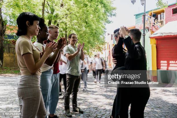 tourists watching street artist dancing tango on caminito, buenos aires, argentina - tango black stock pictures, royalty-free photos & images