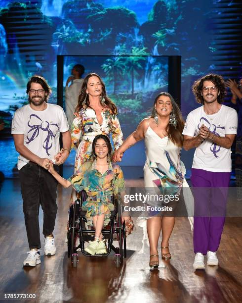 Fashion designers Thomaz Azulay and Patrick Doering with Luiza Brunet and Petra Gil walk the runway during The Paradise fashion show as part of the...