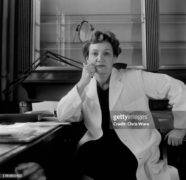 Greek scientist Amalia, Lady Fleming , seated at her desk at St Mary's Hospital in London, October 1958. She is working at the same desk and in the...