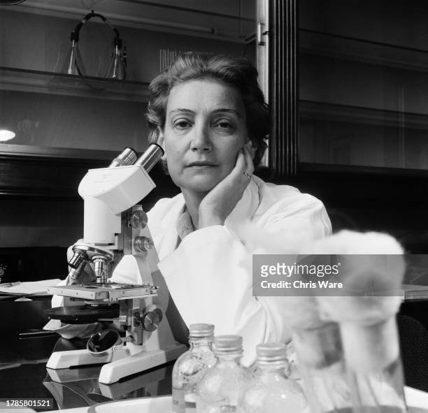 Greek scientist Amalia, Lady Fleming , seated in front of a microscope at St Mary's Hospital in London, October 1958. She is working in the same room...