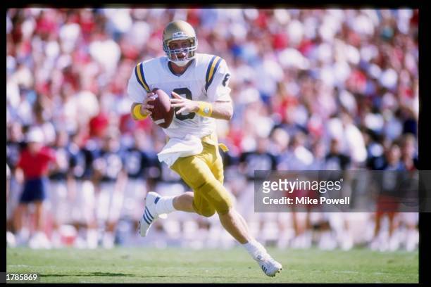 Quarterback Troy Aikman of the UCLA Bruins runs down the field during a game against the Arizona Wildcats at Arizona Stadium in Tucson, Arizona. UCLA...