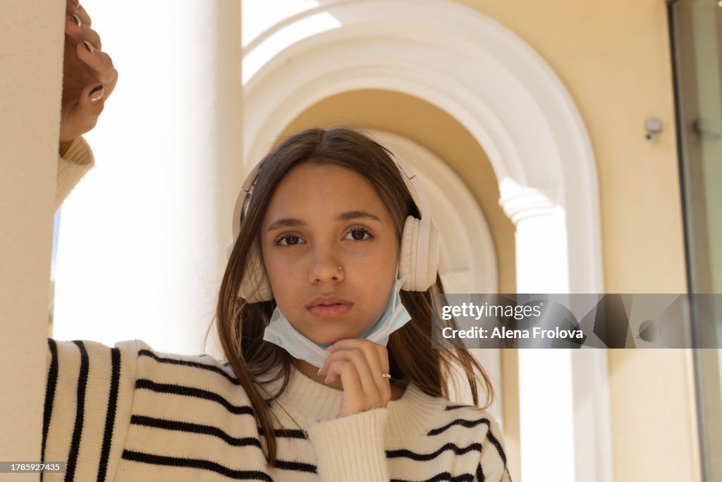 Portrait of beautiful young woman dressing mask