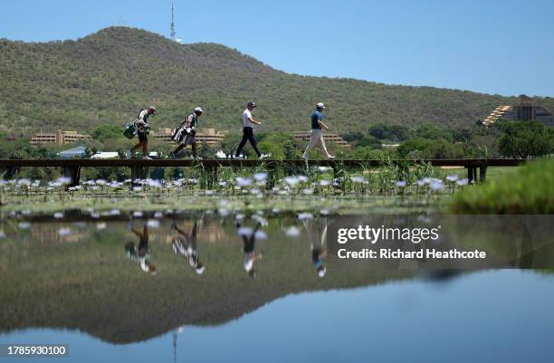 Justin Thomas of the United States and Branden Grace of South Africa walk across a bridge on the 17th hole during Day Two of the Nedbank Golf...