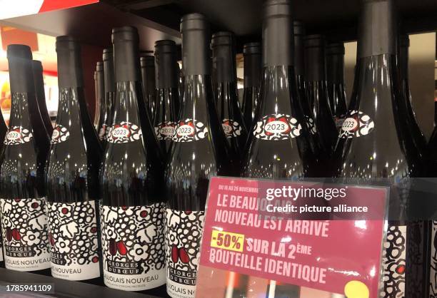 November 2023, France, Paris: Bottles of Beaujolais nouveau wine stand on a supermarket shelf. The first wine of the year from Beaujolais arrived in...