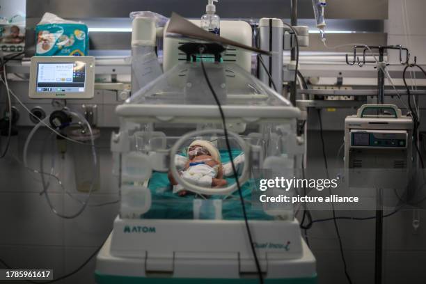 November 2023, Palestinian Territories, Khan Yunis: A newborn infant receives care inside an incubator at Nasser Hospital's nursery department....