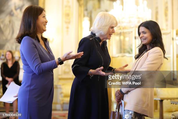Queen Camilla speaks with Britain's Prime Minister wife Akshata Murty and Dr Linda Yueh as she hosts a reception at Buckingham Palace for winners of...