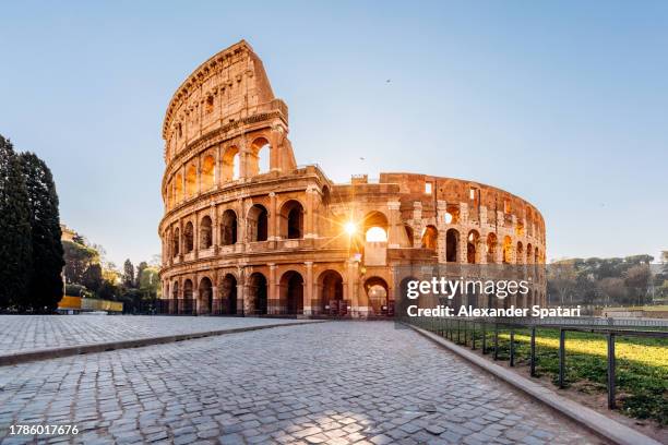 sunrise seen through the arches of coliseum in the morning, rome, italy - views of rome the eternal city stock pictures, royalty-free photos & images