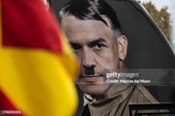 Bus of far right group Hazte Oir is seen with a picture of socialist leader PSOE Pedro Sanchez with a painted Adolf Hitler moustache driving in...