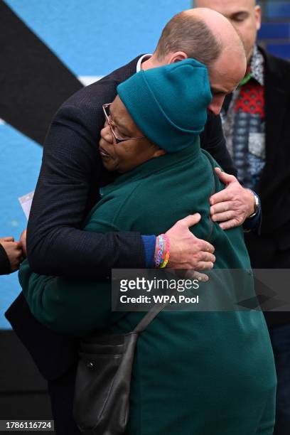 Britain's Prince William, Prince of Wales hugs Barbara Reid mother of Jessie James, a teenager shot dead in 2006 in a park in Moss Side, after...