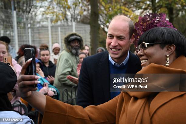 Britain's Prince William, Prince of Wales poses for pictures with a well-wisher as he visits the Millennium Powerhouse, a multi-service youth hub...