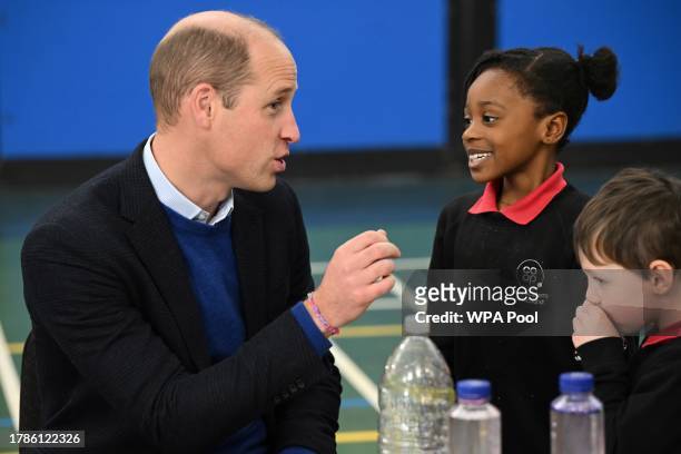 Britain's Prince William, Prince of Wales speaks with children during a visit of the Millennium Powerhouse, a multi-service youth hub which works...