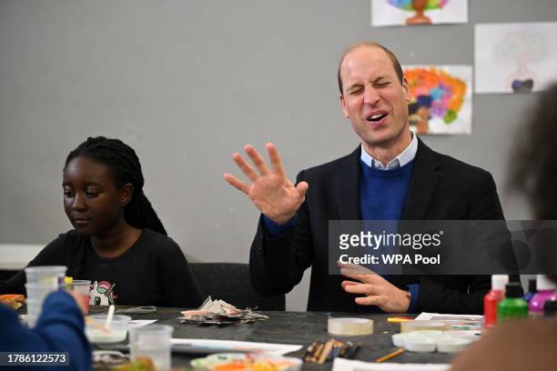 Britain's Prince William, Prince of Wales speaks with children as he visits the Millennium Powerhouse, a multi-service youth hub which works with a...