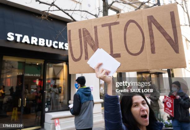 Steph Kronos , a pro-Union activist, joins Starbucks workers, former employees, and supporters in holding signs in support of a strike, outside of a...