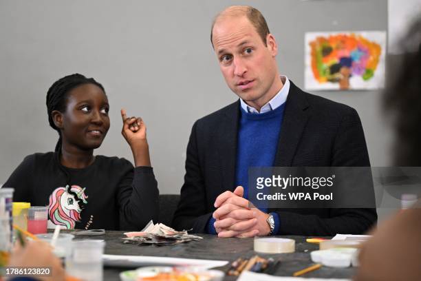 Britain's Prince William, Prince of Wales speaks with children as he visits the Millennium Powerhouse, a multi-service youth hub which works with a...