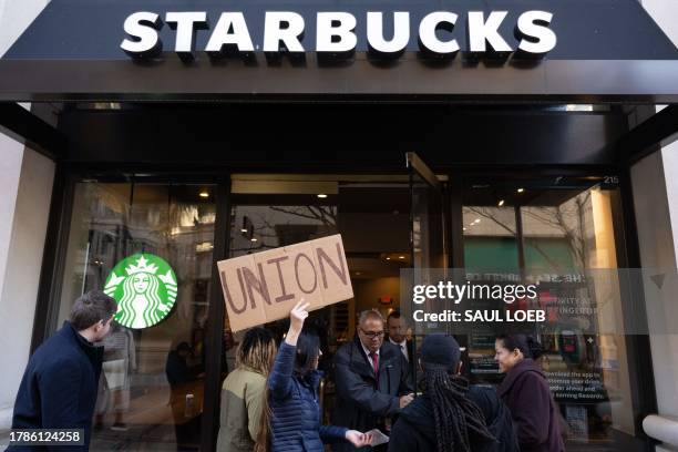 Steph Kronos, a pro-Union activist, tries to talk to Starbucks customers as she joins Starbucks workers, former employees, and supporters in holding...