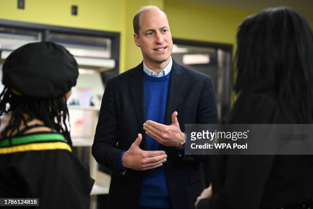 Britain's Prince William, Prince of Wales speaks with members of staff as he visits the Millennium Powerhouse, a multi-service youth hub which works...