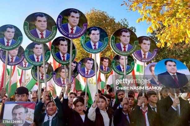 People with Tajikistan's national flags and portraits of President Emomali Rahmon rally in honour of the Tajik leader in the capital Dushanbe on...