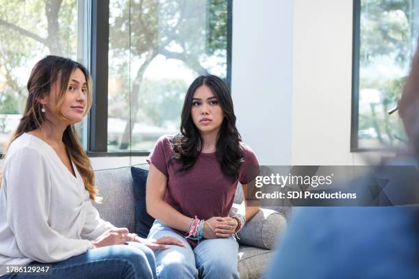 mother and daughter listen to advice from unrecognizable counselor - mediation stock pictures, royalty-free photos & images
