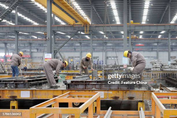 Workers in a factory of prefab construction parts in Huaibei city in central China's Anhui province.