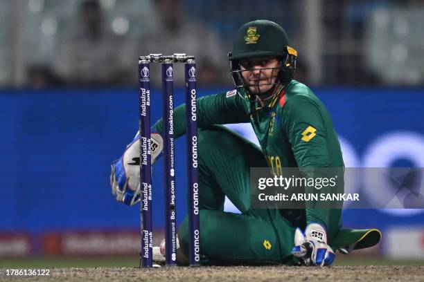 South Africa's wicketkeeper Quinton de Kock reacts during the 2023 ICC Men's Cricket World Cup one-day international second semi-final match between...