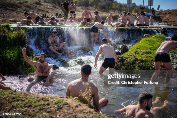 Israeli infantry soldiers take a break from military duties and bathe in a hot spring in the Golan Heights near the Israeli border with Lebanon on...