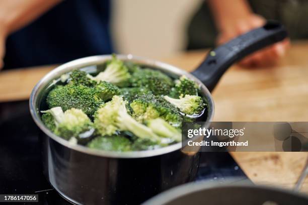 closeup of broccoli boiling in the pan - boiling stock pictures, royalty-free photos & images