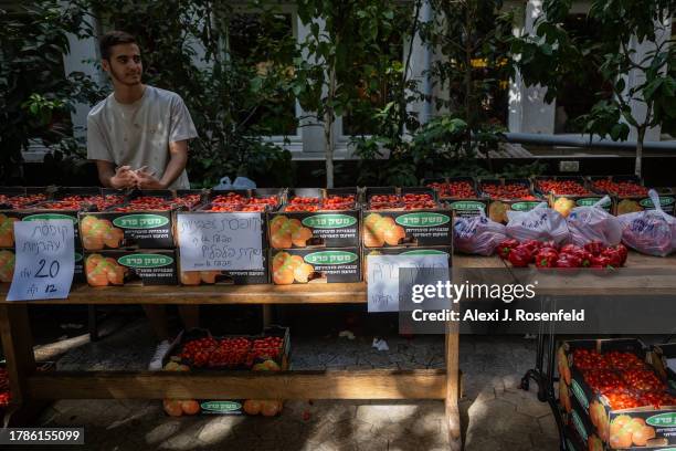 People buy vegetables grown by southern communities near the gaza border, during an outdoor market to support the communities attacked and have been...