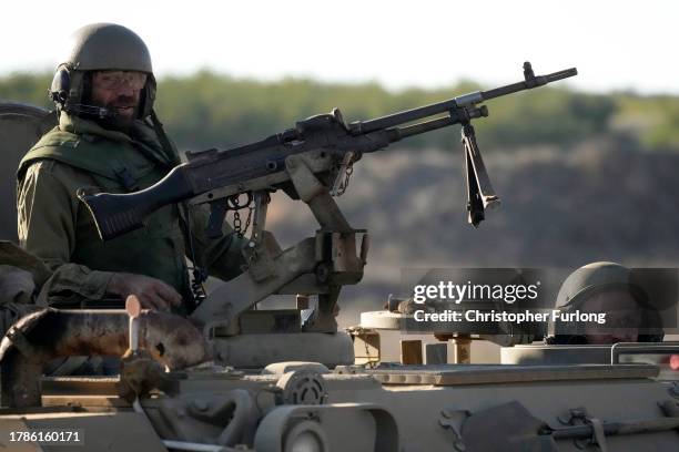 Israeli soldiers stand ready in their armoured personnel carrier in the Golan Heights near the Israeli border with Lebanon on November 10, 2023 near...