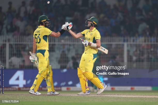 Australia's Mitchell Starc and Australia's captain Pat Cummins celebrate their team's win over South Africa during the ICC Men's Cricket World Cup...