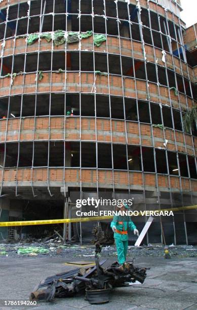 State workers pick up remains, 17 October 2002, left by the carbomb that exploded this morning in the center of Medellin. According to the...