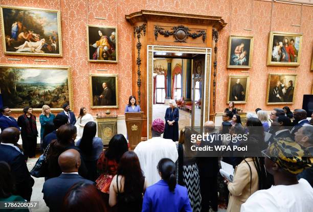 Queen Camilla listens as Dr Linda Yueh speaks as she hosts a reception at Buckingham Palace for winners of The Queen's Commonwealth Essay Competition...