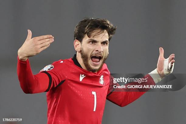 Georgia's midfielder Khvicha Kvaratskhelia celebrates after scoring the team's first goal during the UEFA Euro 2024 football tournament Group A...