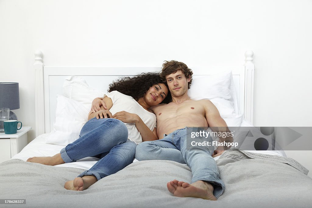 Couple lying on bed together