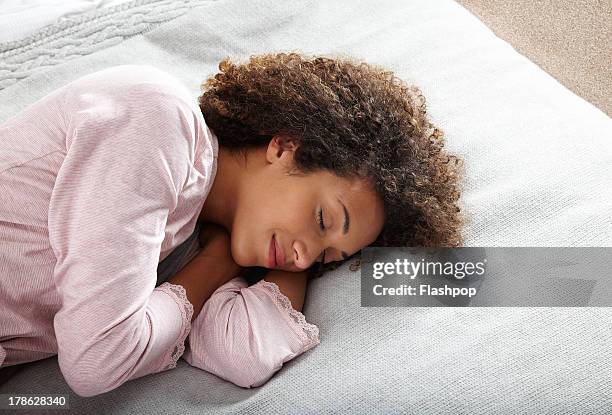 woman relaxing on bed - woman sleeping stock pictures, royalty-free photos & images
