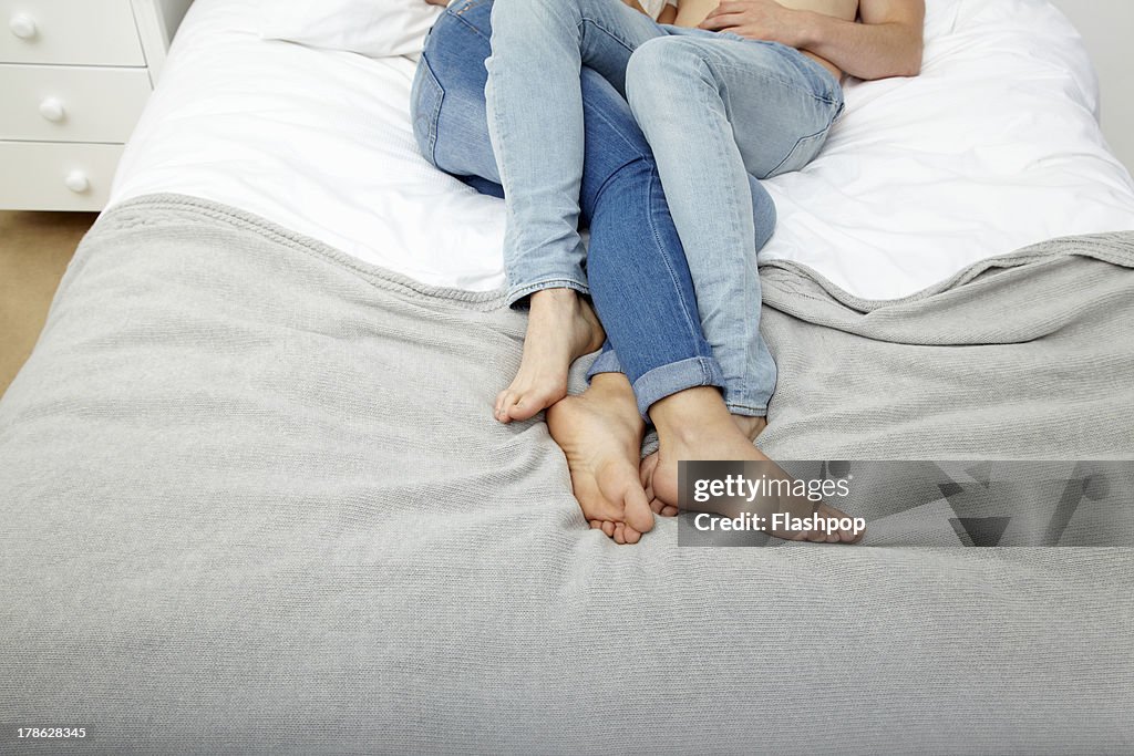 Couple lying on bed together