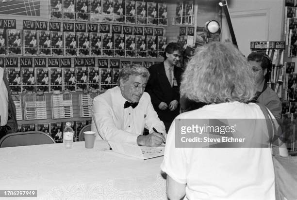 View of American Pop and Jazz musician Tony Bennett as he attends a CD release event at a Sam Goody record store, New York, New York, September 19,...