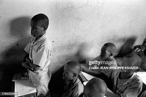 Children attend 22 March 2001 class in a Koranic school in a low-income neighborhood of Abidjan. Muslim children in Abidjan's poor neighborhoods of...