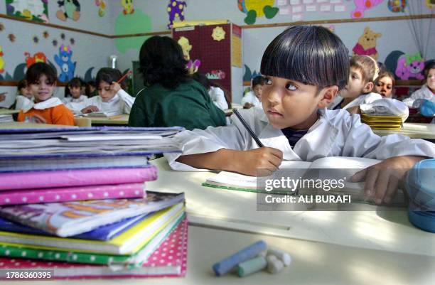 Third grade students take notes during a class 17 April 2002 in a classroom at the Buque Fragata Sarmiento school in San Francisco Solano, Argentina....