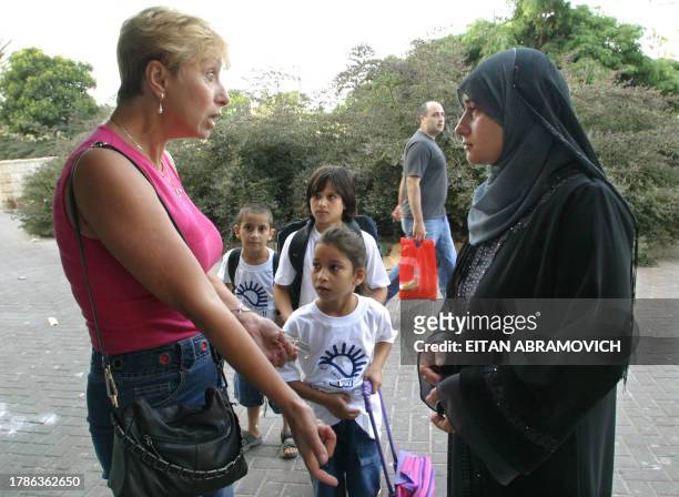 Jewish Israeli woman argues with an Arab Israeli mother arriving with her with her children to a new Arab school in the Kiryat Menachem neighborhood...