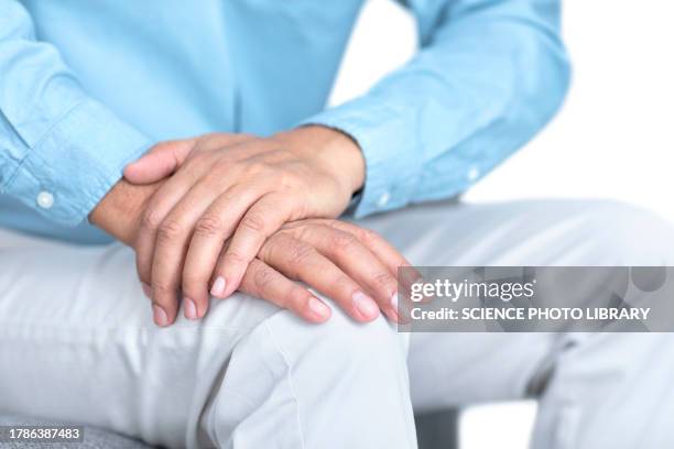 man clasping hand on knee - shaking stock pictures, royalty-free photos & images
