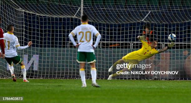 Bulgaria's forward Kiril Despodov scores a penalty past Hungary's goalkeeper Denes Dibusz during the UEFA Euro 2024 Group G qualification football...