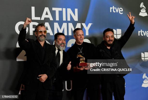 Members of Mexican band Molotov pose with the trophy after receiving the Best Rock Album award during the 24th Annual Latin Grammy Awards ceremony at...