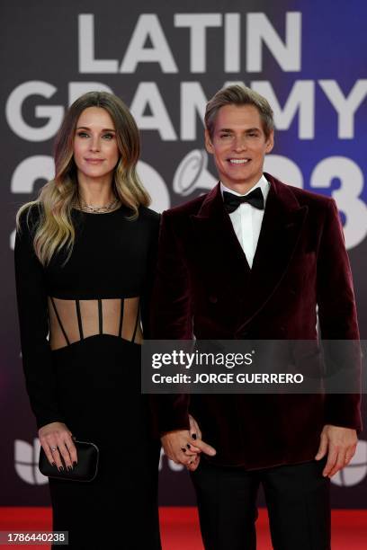 Venezuelan singer-songwriter and television host Carlos Baute and his wife Astrid Klisans arrive at the 24th Annual Latin Grammy Awards ceremony at...